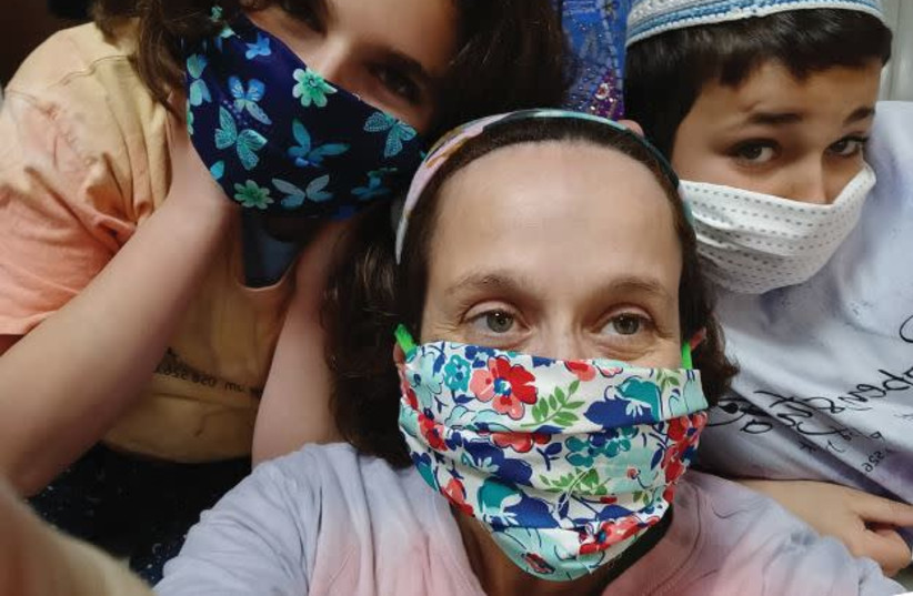 AVIGAYLE ADLER and her children with masks made from a kit. (photo credit: Courtesy)