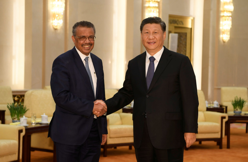 WHO director general Tedros Adhanom shakes hands with Chinese President Xi Jingping, Jan. 2020 (credit: NAOHIKO HATTA/POOL VIA REUTERS)
