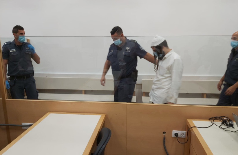 Amiram Ben-Uliel appears at Lod District Court ahead of his conviction in the Duma arson case, May 18, 2020 (credit: YONAH JEREMY BOB)