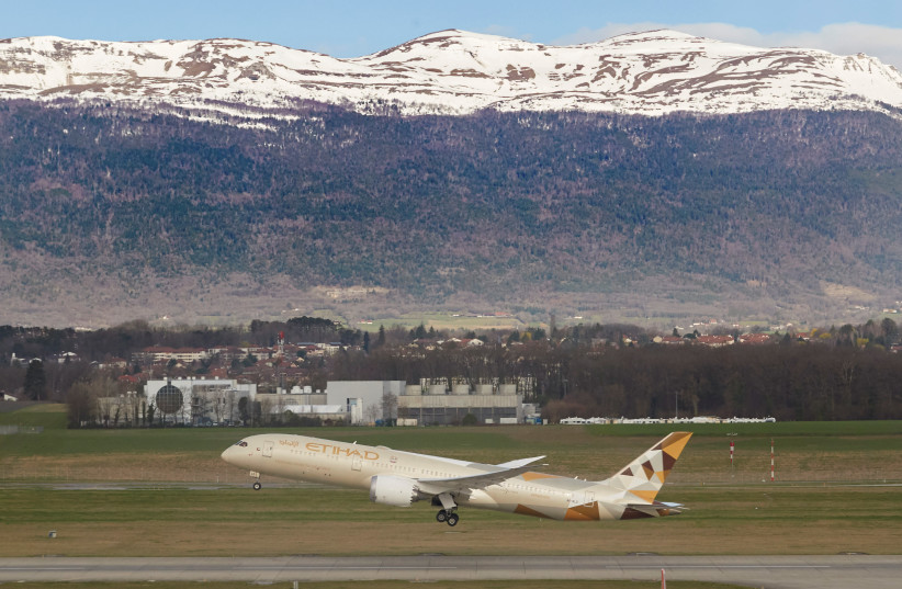 An Etihad Boeing 787-9 Dreamliner aircraft takes off at Cointrin Airport during the outbreak of the coronavirus disease (COVID-19) in Geneva, Switzerland, March 13, 2020 (photo credit: REUTERS/DENIS BALIBOUSE)