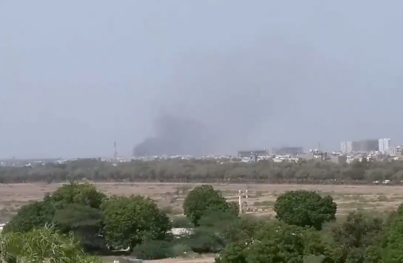 A plume of smoke is seen after the crash of a PIA aircraft in Karachi, Pakistan May 22, 2020 (photo credit: TWITTER/SHAHABNAFEES VIA REUTERS)