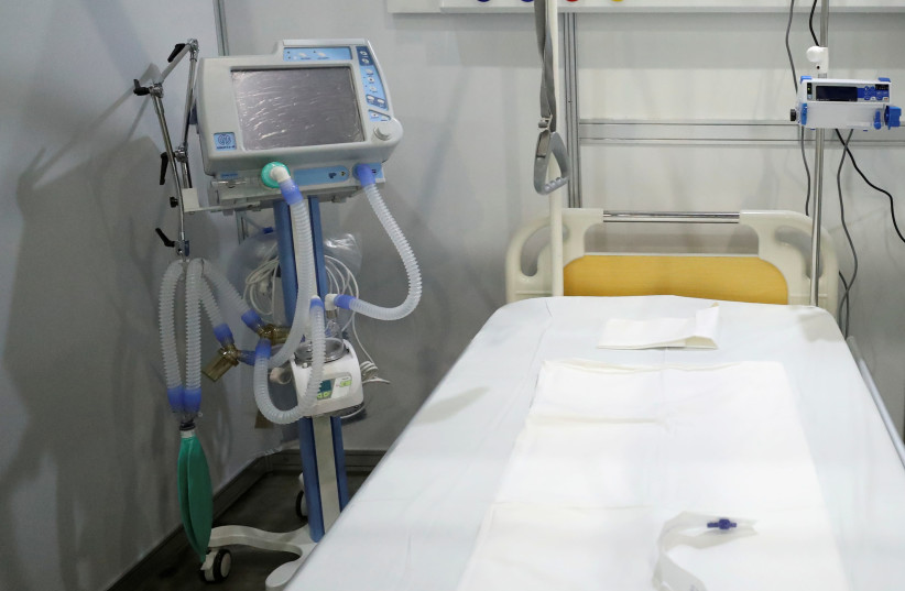 A view shows an Aventa-M medical ventilator next to a bed inside a pavilion of Crocus Expo exhibition centre, turned into a temporary hospital amid the coronavirus disease (COVID-19) outbreak, on the outskirts of Moscow, Russia May 11, 2020 (photo credit: REUTERS)