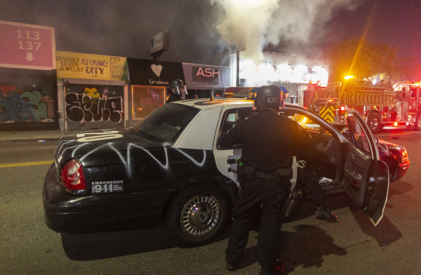 A vandalized police car during the protests in Los Angeles, May 30, 2020.  (photo credit: DAVID MCNEW/GETTY IMAGES/JTA)