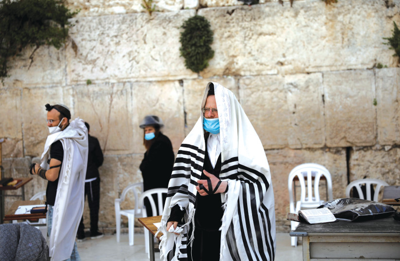 SPREADING PRAYER and love from the Western Wall. (photo credit: REUTERS)