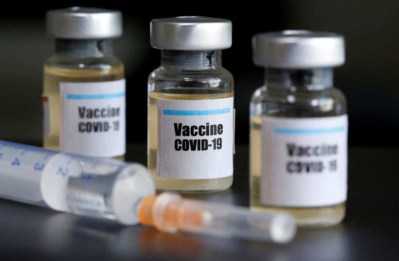 Small bottles labeled with a "Vaccine COVID-19" sticker and a medical syringe are seen in this illustration (photo credit: REUTERS/ DADO RUVIC)