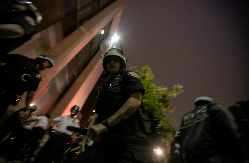 A NYPD policeman is seen during a protest against the death in Minneapolis police custody of George Floyd, in the Brooklyn borough of New York City, U.S., June 3, 2020. (photo credit: REUTERS)