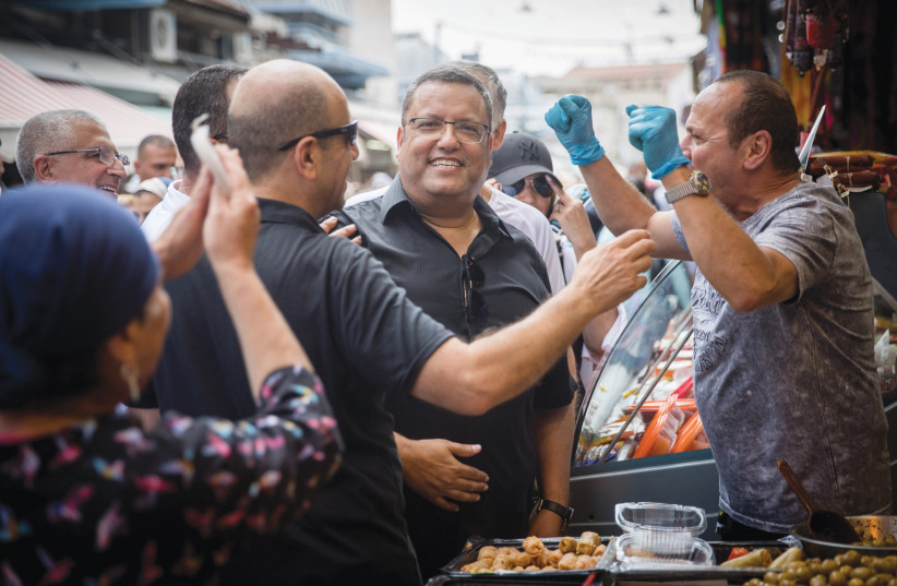 MOSHE LION campaigns in the shuk during the 2018 mayoral race from which he emerged victorious.  (photo credit: YONATAN SINDEL/FLASH90)
