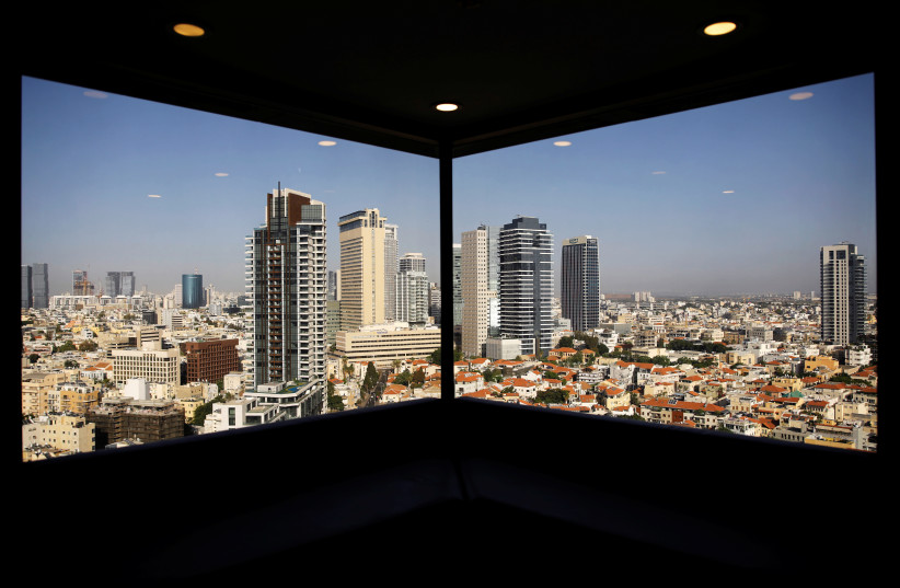 A general view of Tel Aviv's skyline is seen through a hotel window in Tel Aviv (photo credit: REUTERS)