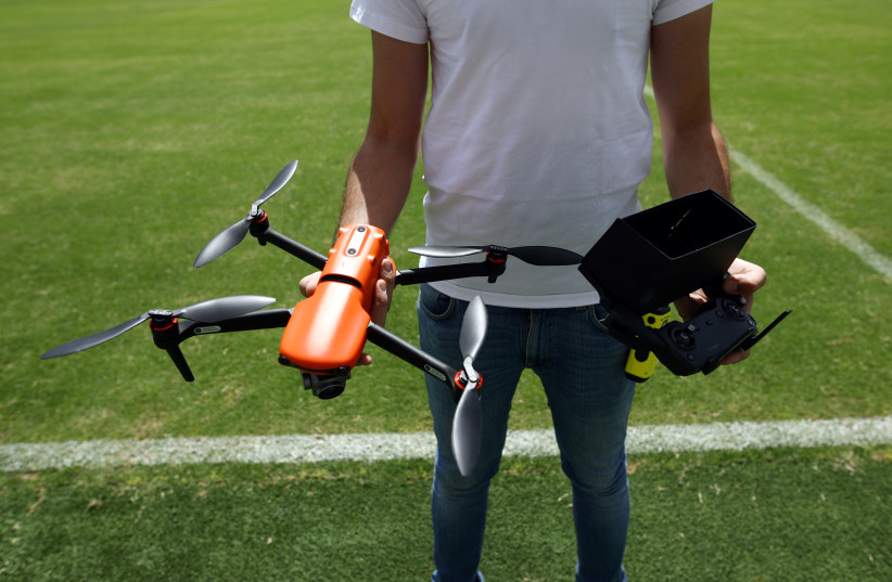 A test drone operator prepares to launch a drone during a demonstration of Israel's NSO Group's product, Eclipse, a system that commandeers and force-lands intruding drones, at Bloomfield Stadium, in Tel Aviv, Israel June 8, 2020 (photo credit: AMMAR AWAD / REUTERS)