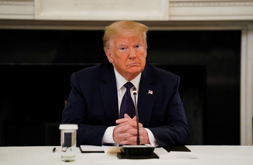 FILE PHOTO: U.S. President Donald Trump listens during a roundtable discussion with law enforcement in the State Dining Room at the White House in Washington, U.S., June 8, 2020. (photo credit: KEVIN LAMARQUE/REUTERS)