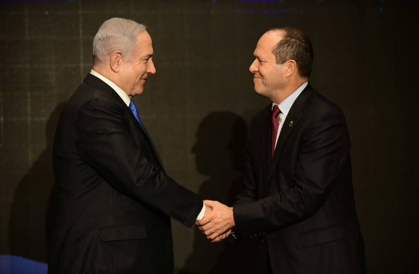 Nir Barkat and Prime Minister Benjamin Netanyahu present the Likud economic plan during a party event in Tel Aviv on February 16. (photo credit: TOMER NEUBERG/FLASH90)