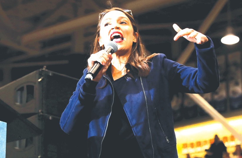 US REP. Alexandria Ocasio Cortez introduces Sen. Bernie Sanders at a campaign rally before the New Hampshire presidential primary in Durham, New Hampshire (photo credit: REUTERS/MIKE SEGAR)
