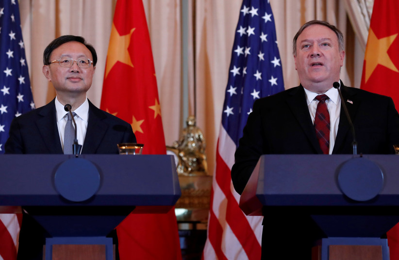 U.S. Secretary of State Mike Pompeo, right, speaks as Chinese Communist Party Office of Foreign Affairs Director Yang Jiechi listens as the two countries hold a joint news conference after participating in a second diplomatic and security meeting at the U.S. Department of State, Washington, U.S., No (photo credit: REUTERS/LEAH MILLIS)