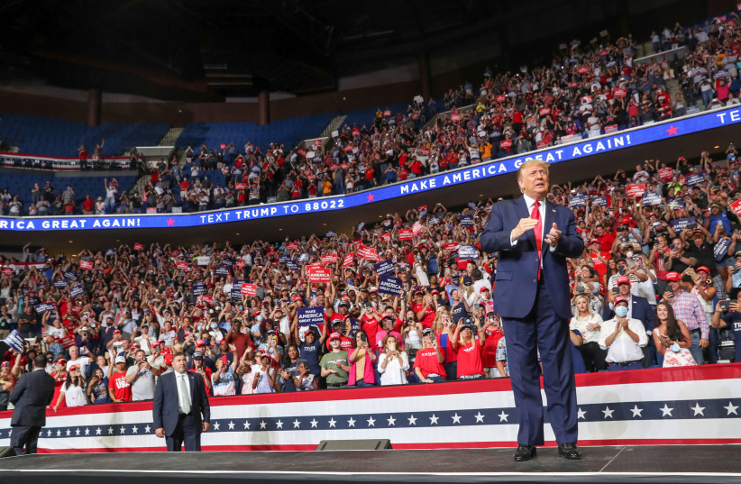 U.S. President Donald Trump reacts to the crowd as he arrives onstage at his first re-election campaign rally in several months in the midst of the coronavirus disease (COVID-19) outbreak, at the BOK Center in Tulsa, Oklahoma, U.S., June 20, 2020 (photo credit: REUTERS/LEAH MILLIS)