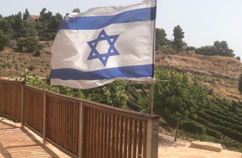 An Israeli flag is seen at the Elon Moreh settlements, one of 15 pending enclave communities under the Trump plan. (credit: TOVAH LAZAROFF)