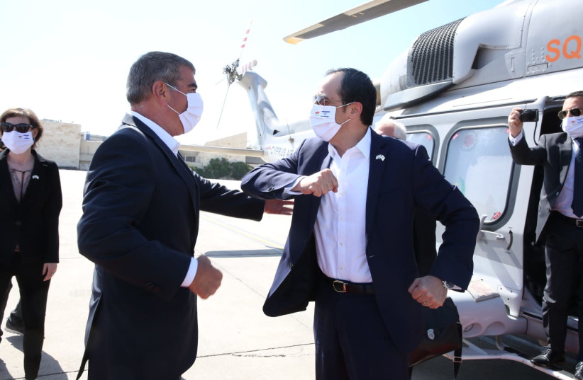 Israel Foreign Minister Gabi Ashkenazi greets Cypriot Foreign Minister Nikos Christodoulides upon his arrival on June. 23. 2020. (photo credit: MIRI SHIMONOVICH/GPO)