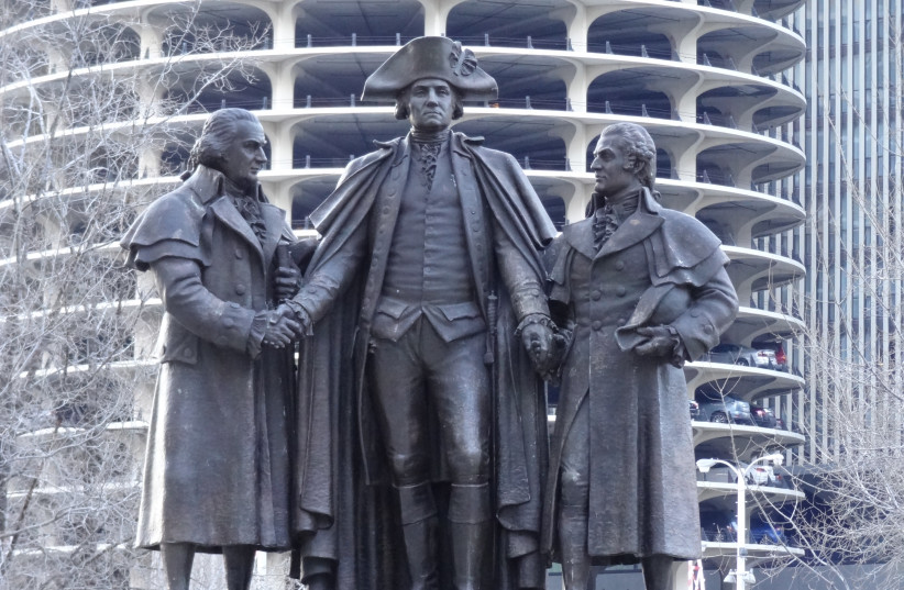 IN THIS memorial along the Chicago River, George Washington, in his Revolutionary War uniform, shakes hands with English-born Robert Morris on his right and Polish-Jewish emigrant Salomon on his left. Morris, a signer of the Declaration of Independence, and Salomon provided financial support to assu (credit: FLICKR)