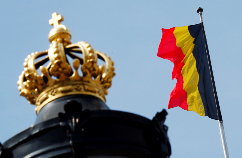 A Belgian national flag flies over the Royal Palace (photo credit: FRANCOIS LENOIR / REUTERS)
