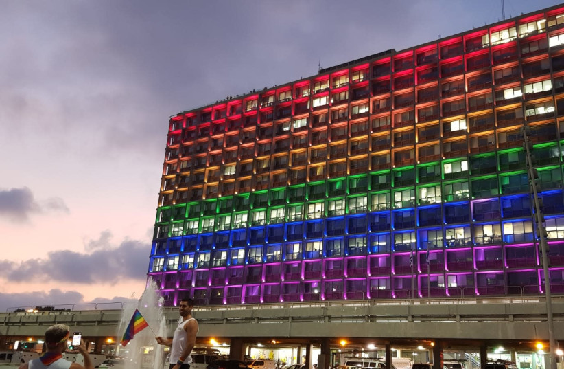 The outside of the Tel Aviv Municipality is lit up to resemble the LGBT Pride flag. (credit: COURTESY OF TEL AVIV-YAFO MUNICIPALITY)