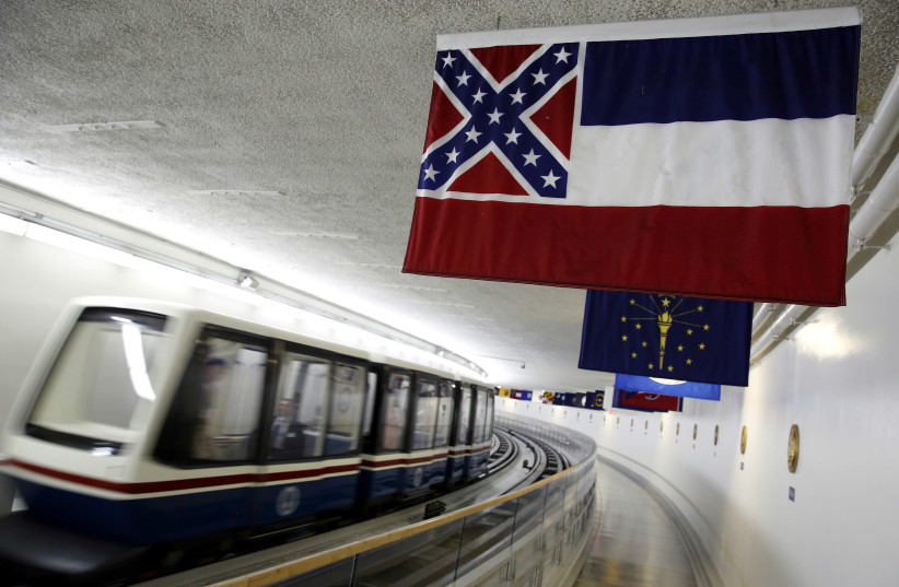 The Mississippi state flag, which incorporates the Confederate battle flag, hangs with other state flags in the subway system under the U.S. Capitol in Washington June 23, 2015. (photo credit: JONATHAN ERNST / REUTERS)
