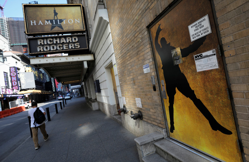A man walks past the shuttered Richard Rodgers Theatre, home of the popular musical ''Hamilton'' after industry group the Broadway League said Broadway theaters will remain closed through January 3, 2021, in New York, U.S., July 2, 2020 (credit: REUTERS/MIKE SEGAR)