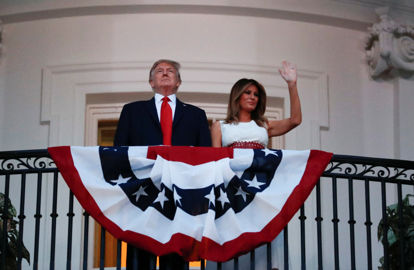 US President Donald Trump and first lady Melania Trump watch the Washington, D.C. fireworks display from the Truman Balcony as they celebrate the US Independence Day holiday at the White House in Washington, US, July 4, 2020 (photo credit: REUTERS/CARLOS BARRIA)