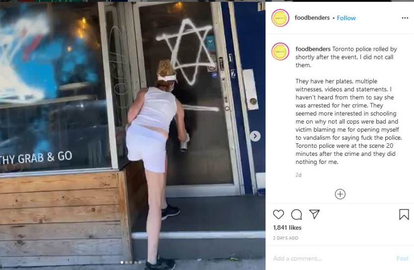 A woman spray painting a Star of David at Foodbenders, in Toronto, Canada. (photo credit: INSTAGRAM)