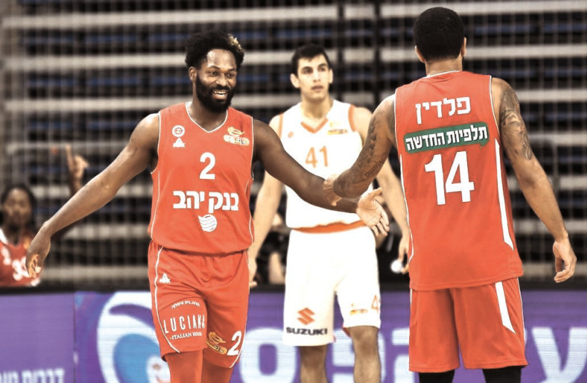 JEREMY PARGO (left) and James Feldeine (right) helped Hapoel Jerusalem earn an 88-73 road triumph over teenager Noam Dovrat (center) and Maccabi Rishon Lezion this week in Israel Winner League action (credit: DOV HALICKMAN PHOTOGRAPHY)