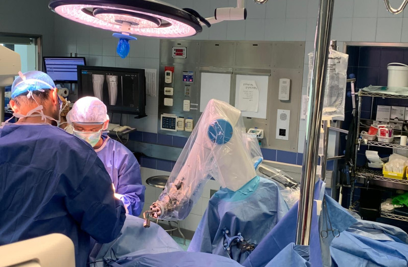 Surgeons doing knee surgery at Hadassah hospital's Mount Scopus campus use the ROSA robot, made possible with a grant from USAID's Office of American Schools and Hospitals Abroad. (credit: GURION RIVKIN)