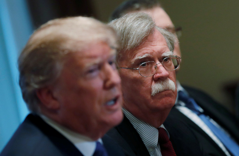 United States President Donald Trump pictured next to Former United States National Security Advisor John Bolton. (photo credit: REUTERS)