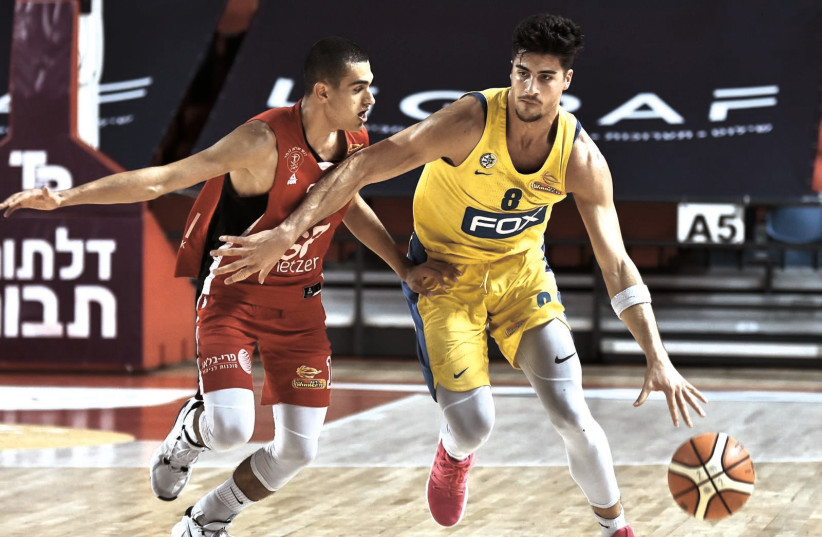 Hapoel TEL AVIV’s Yam Madar (left) got the best of fellow NBA Draft prospect Deni Avdija as the Reds topped Maccabi Tel Aviv in Game 2 of the their quarterfinal duel to set up a win-or-go-home contest tonight for a spot in the Final Four. (photo credit: DOV HALICKMAN PHOTOGRAPHY)