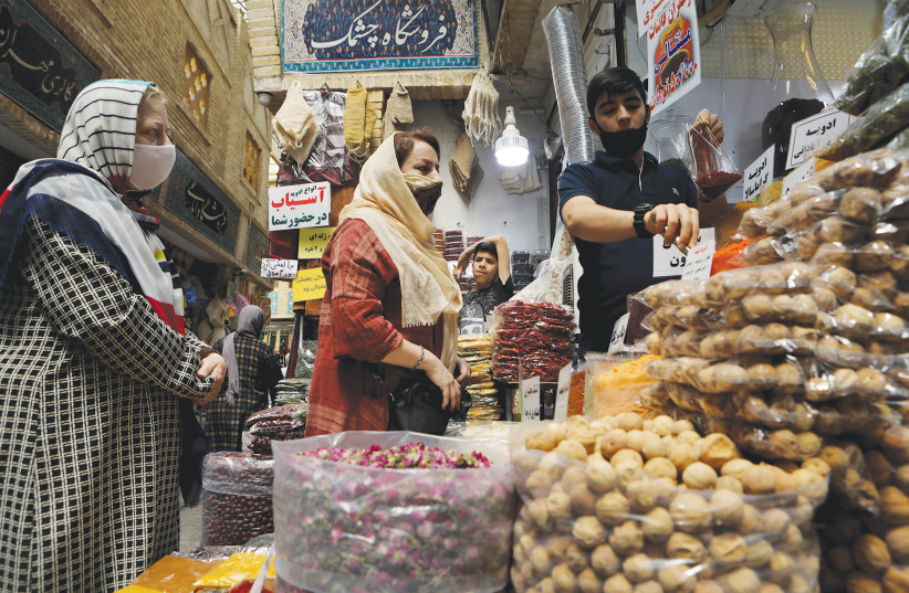 WOMEN WEAR face masks while shopping at a bazaar in Tehran, July 2020 (photo credit: ABDOLLAH HEIDARI/REUTERS)