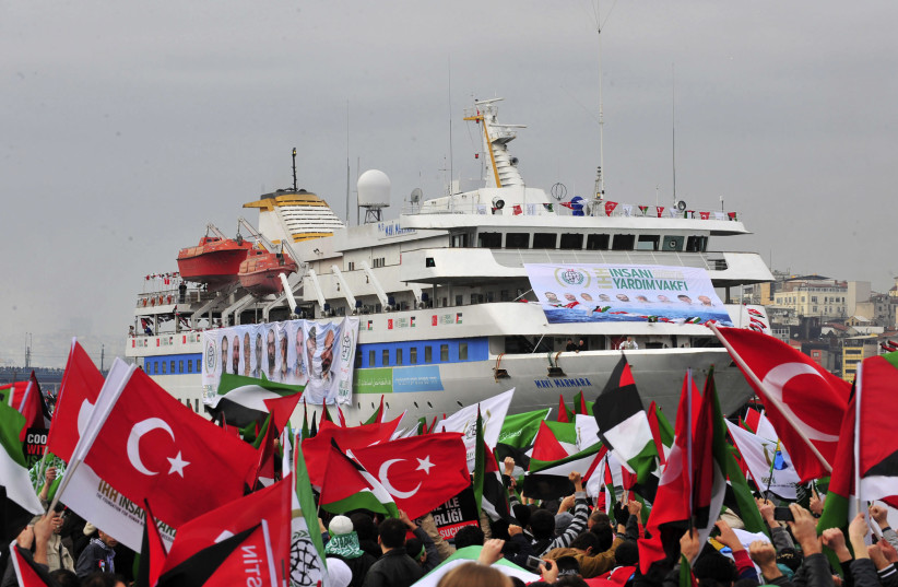 PRO-PALESTINIAN activists wave Turkish and Palestinian flags during the welcoming ceremony for the ‘Mavi Marmara,’ in Istanbul in December 2010. Nine Turkish activists died the previous May when IDF naval commandos stopped the ship. (credit: STRINGER/ REUTERS)