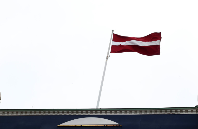 National flag flutters over Latvian central bank headquarters in Riga, Latvia April 9, 2019. (photo credit: INTS KALNINS / REUTERS)