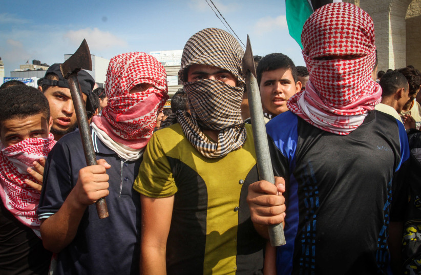 Palestinians take part in an anti-Israel protest in the southern Gaza Strip town of Rafah on October 13, 2015 (photo credit: ABED RAHIM KHATIB/FLASH90)