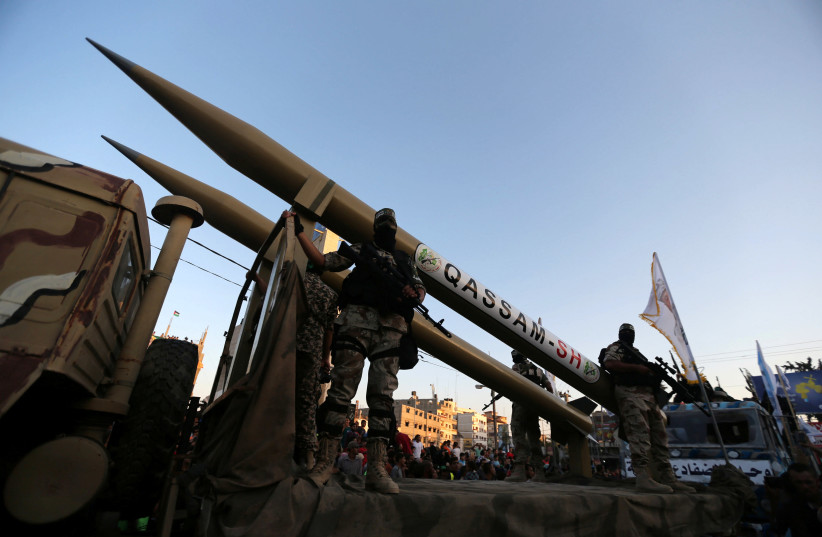 Palestinian members of al-Qassam Brigades, the armed wing of the Hamas movement, display home-made rockets during an anti-Israel military parade, in Rafah in the southern Gaza Strip August 21, 2016 (photo credit: REUTERS/IBRAHEEM ABU MUSTAFA)