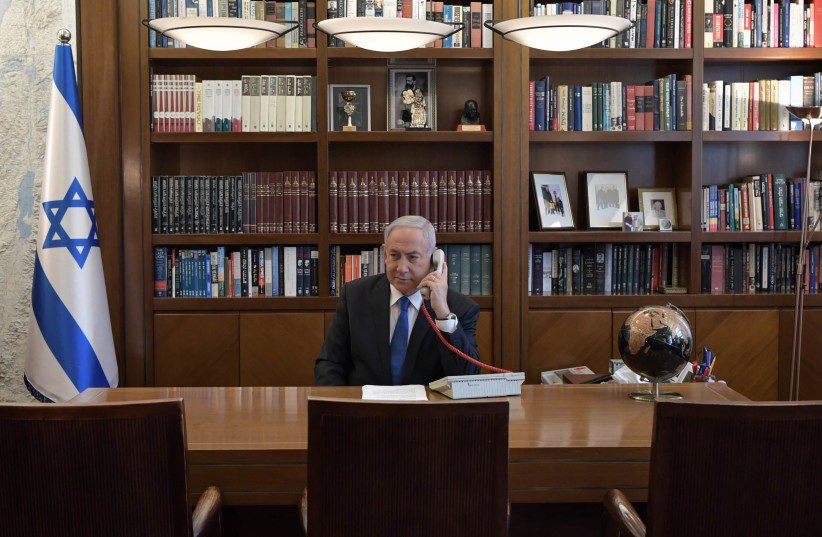 Prime Minister Benjamin Netanyahu holds a telephone conversation in his office with US President Donald Trump and UAE Crown Prince Sheikh Mohamed bin Zayed, August 13, 2020 (photo credit: KOBI GIDEON/GPO)