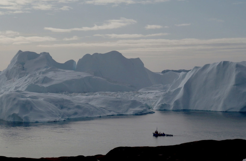 A fishing vessel sails in the ice fjord near Ilulissat, Greenland September 12, 2017 (credit: REUTERS/JACOB GRONHOLT-PEDERSEN/FILE PHOTO)