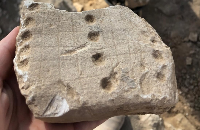 Another gameboard found at the site was called “Hounds and Jackals,” or “58 Holes'' (credit: EMIL ALADJEM/ISRAEL ANTIQUITIES AUTHORITY)