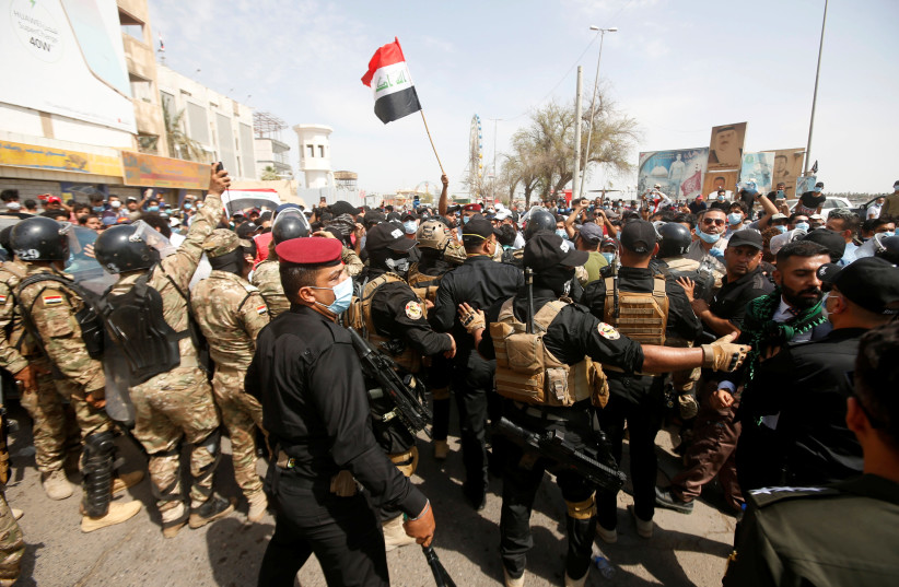 Iraqi security forces push back demonstrators in anti-government protests during Iraqi Prime Minister Mustafa al-Kadhimi's visit, in Basra, Iraq, July 15, 2020 (photo credit: REUTERS/ESSAM AL-SUDANI)