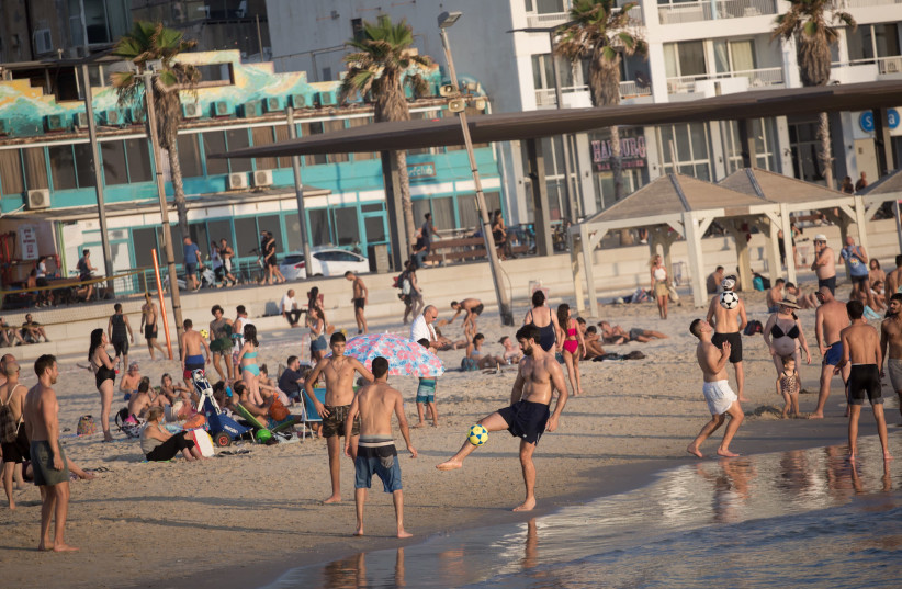 Israelis enjoy the beach in Tel Aviv, Aug. 4, 2020.  (photo credit: MIRIAM ALSTER/FLASH90)