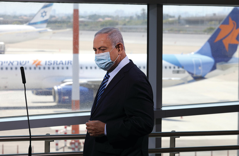 PRIME MINISTER Benjamin Netanyahu is seen preparing to give a statement at Ben-Gurion airport. (photo credit: EMIL SALMAN/REUTERS)