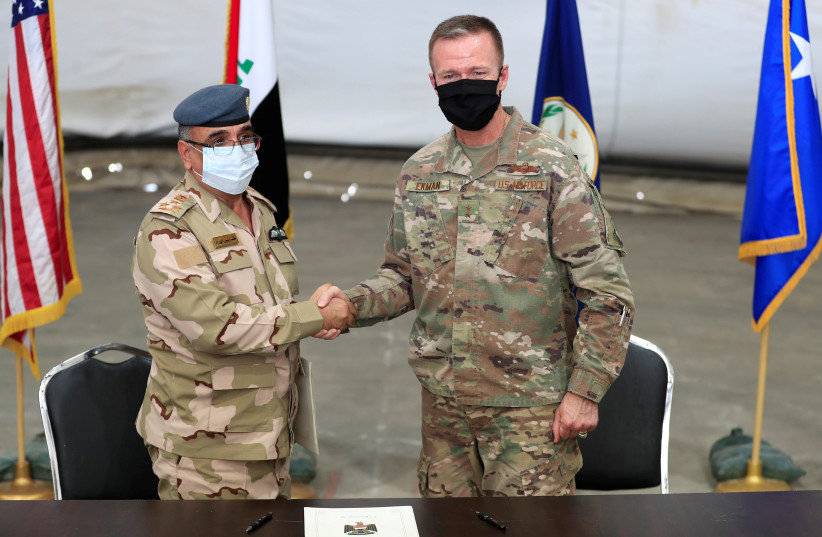 Maj. Gen. Kenneth P. Ekman, Deputy Commander of Combined Joint Task Force-Operation Inherent Resolve, shakes hand with Brigadier General Salah Abdullah during a handover ceremony of Taji military base from US-led coalition troops to Iraqi security forces, in the base north of Baghdad, Iraq August 23 (photo credit: REUTERS/THAIER AL-SUDANI)
