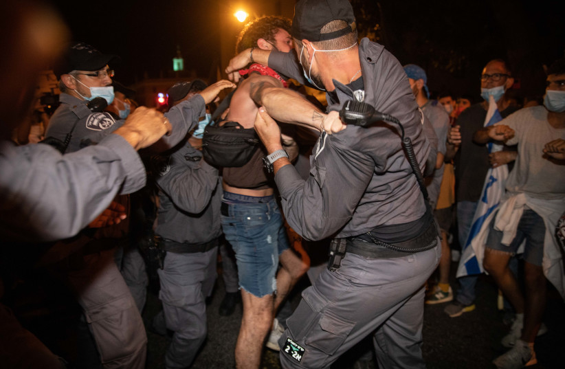Police officers arrest a demonstrator during protests against Prime Minister Benjamin Netanyahu, Jerusalem, August 22, 2020 (photo credit: NOAM REVKIN FENTON/FLASH90)