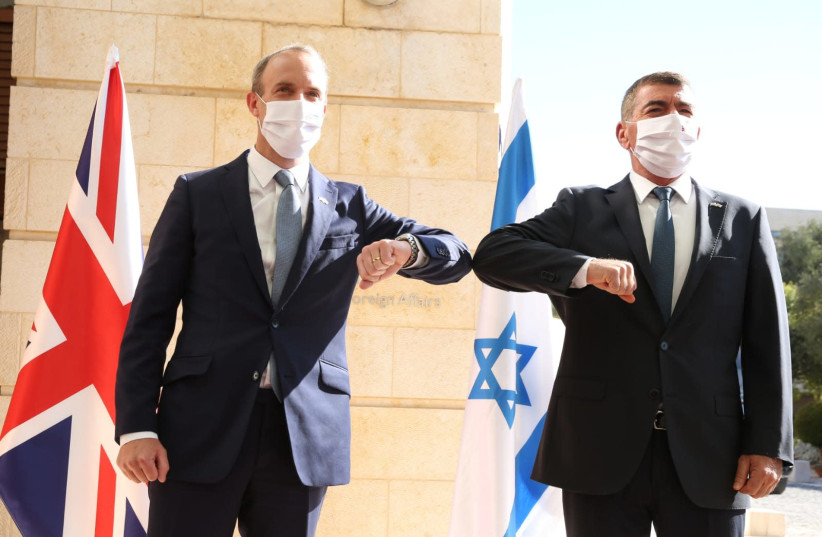 UK Foreign Secretary Dominic Raab meets Israeli Foreign Minister Gabi Ashkenazi on his arrival in Israel, August 25, 2020 (photo credit: MIRI SHIMONOVICH/GPO)