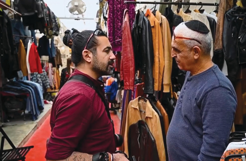 Rawarpoor stumbles upon a Persian-Israeli in a Tel viv flea market, where they exchange views on the current situation in Iran (photo credit: COURTESY OF HUMAN DAVID RAWARPOOR/INSTAGRAM/MANOTO)