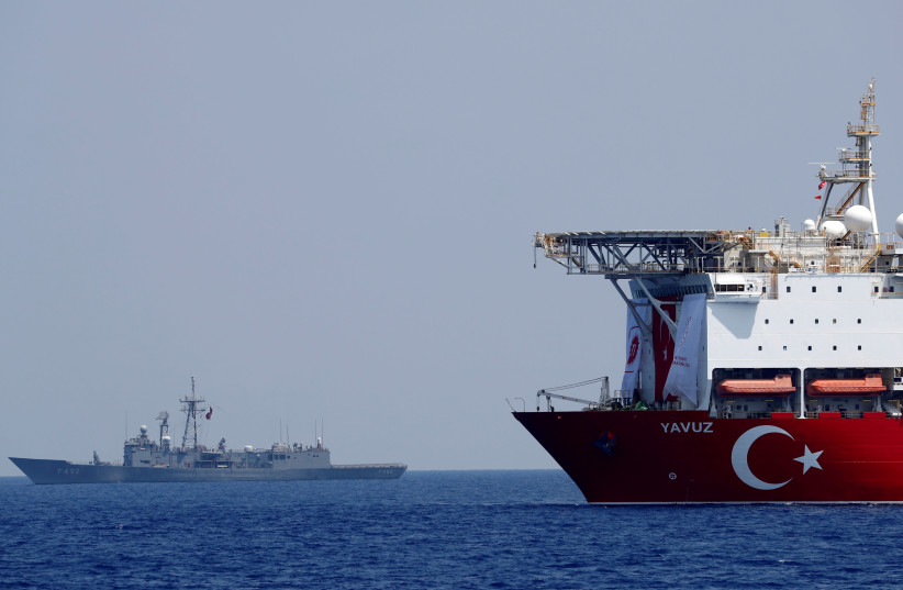The Turkish drilling vessel Yavuz is seen being escorted by a Turkish Navy frigate in the eastern Mediterranean off Cyprus, August 6, 2019 (photo credit: REUTERS)