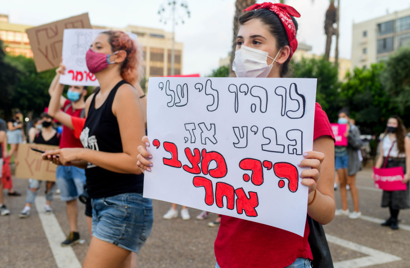 Womens' rights activists protest against violence against women at Rabin Square in Tel Aviv, August 30, 2020 (photo credit: AVSHALOM SASSONI/FLASH90)