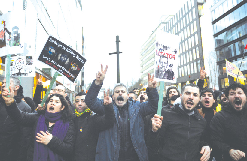 DEMONSTRATORS PROTEST a visit of Turkey’s President Recep Tayyip Erdogan in Brussels, March 2020. (photo credit: JOHANNA GERON/REUTERS)