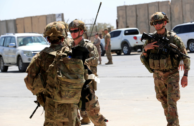 U.S. soldiers are seen during a handover ceremony of Taji military base from US-led coalition troops to Iraqi security forces, in the base north of Baghdad, Iraq August 23, 2020. (photo credit: THAIER AL-SUDANI/REUTERS)